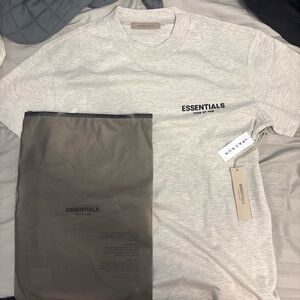 Fear of God ESSENTIALS Tee in Light Beige with Black Logo
